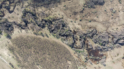 Barren landscape with a river running through it. Spring awakening of nature.