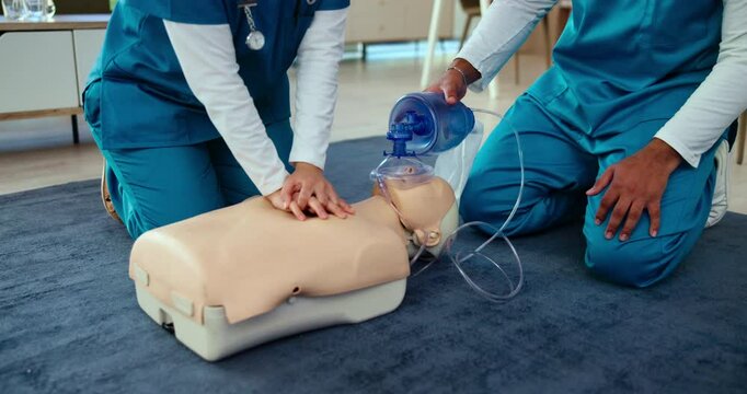 AED, training and doctor with cpr on dummy for cardiac arrest, emergency rescue and life saving teamwork. Medical simulation, people and hands with chest compression for heart attack and practical