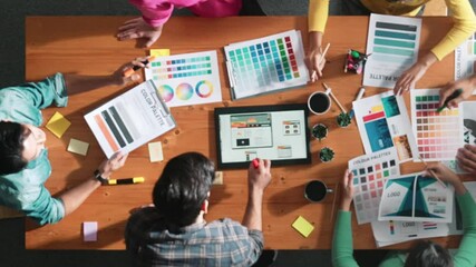 Top view of business people working together to design web design. Aerial view of designer brainstorming and discussing about website interface and looking at tablet with digital design. Symposium. - Powered by Adobe