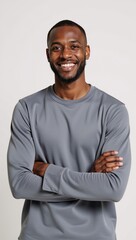 A joyful African-American man is depicted with his arms crossed