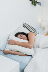latin woman sleeping with closed eyes on bed in the morning at home in Mexico Latin America,...