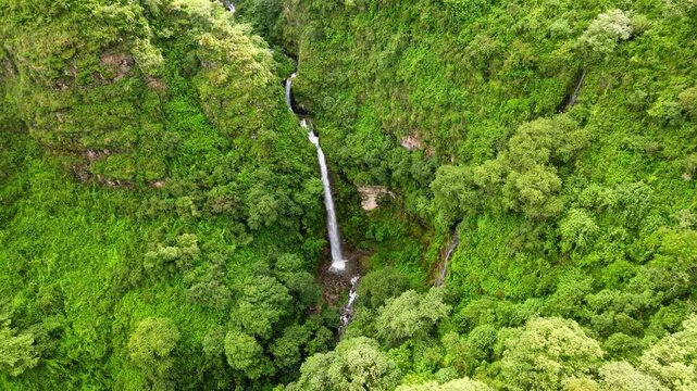 drone traveling in waterfall  green mountain