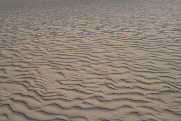 Sand patterns created by winds in Socotra Zahek Sand Dunes, Yemen, showcasing natural beauty and unique geography