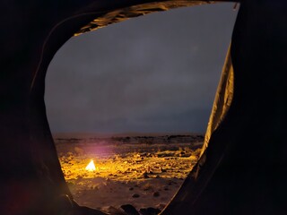 Exploring the Socotra Zahek Sand Dunes at night in Socotra, Yemen with illuminated camp beneath a...