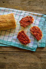 Ajvar - red pepper spread on bread. Vertical photo. Traditional Balkan food. 