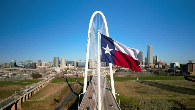 Texas state flag and Modern Margaret Hunt Hill Bridge over Trinity river in Dallas, Texas