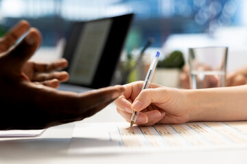 Person signing contract after qualifications aligned with company expectations. Close up of...