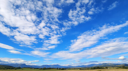 Fototapeta premium beautiful landscape featuring vast blue sky with fluffy white clouds, rolling hills
