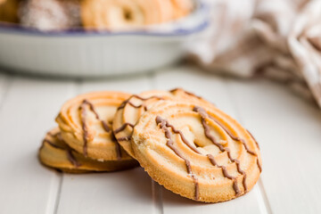 Sweet chocolate cookies on white table.