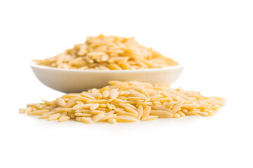 Orzo, kritharaki, risoni pasta. Uncooked dry pasta in bowl isolated on white background.