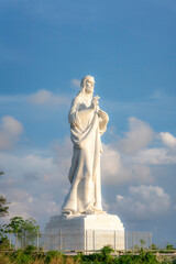 Fototapeta premium The Cristo de La Habana, a towering white marble statue of Jesus Christ, stands against a blue sky in Havana, Cuba, symbolizing faith and peace. 