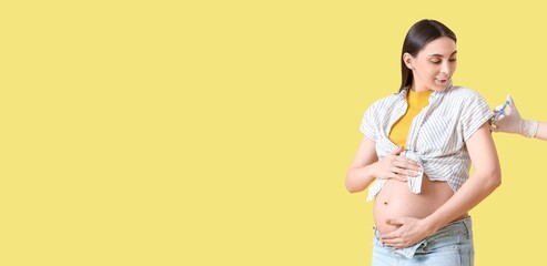 Young pregnant woman receiving vaccine on yellow background with space for text
