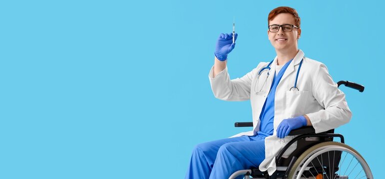 Male doctor in wheelchair holding syringe on light blue background with space for text