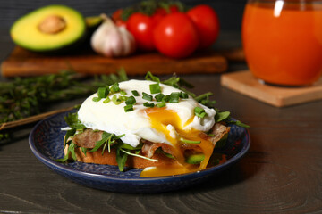 Plate with tasty egg Benedict on table