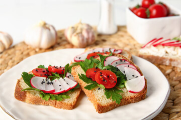 Plate with delicious radish bruschettas on wicker mat, closeup