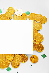 Blank card with golden coins and sequins on light background. St. Patrick's Day celebration