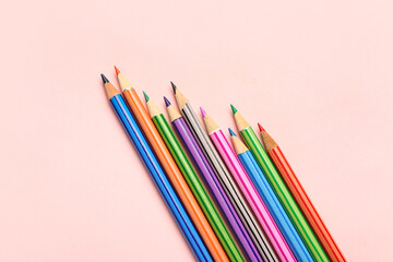 Group of colorful pencils on pink background