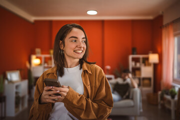 young beautiful woman use mobile phone for fun at home