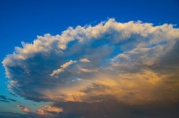 Real amazing panoramic sunrise or sunset sky with gentle colorful clouds. Stormy clouds. Cumulonimbus