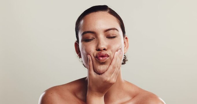 Face, lips and woman with skincare, cosmetics and dermatology on studio background. Portrait, person and model with expression, sugar scrub and aesthetic with beauty, wellness and remove acne