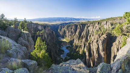 Dramatic canyon landscape with a river winding below majestic cliffs