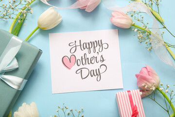 Card with text HAPPY MOTHER'S DAY, gift boxes and beautiful flowers on blue background