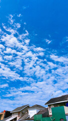 Modern minimalist architecture set against a sunny blue sky.