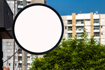 Blank circular shop signboard mockup for design. Street hanging sign board for logo presentation. Cafe restaurant or bar badge black white round, in Brazil