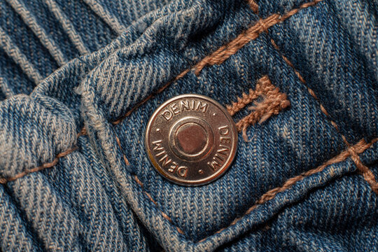 Button and seams of a denim garment