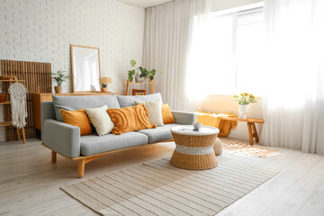 Interior of modern light living room with sofa and table