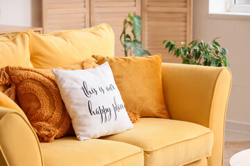 Yellow sofa with cushions in living room. Closeup
