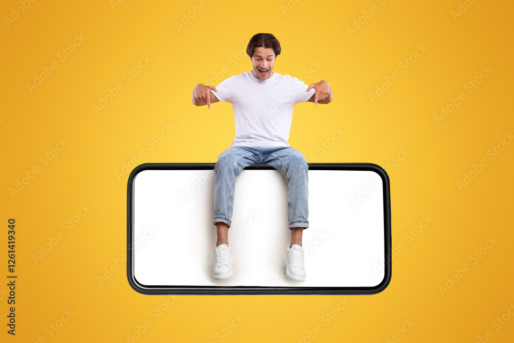 Poster mobile app advertisement. handsome excited man sitting on white empty smartphone screen and pointing