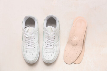 Shoes with orthopedic insoles on light background