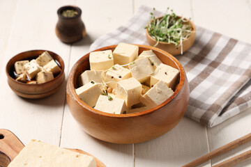 Tasty tofu cheese on white wooden background