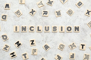 Word INCLUSION with letters on light grunge background