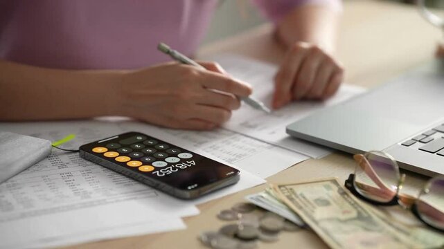 Businesspeople or accountant using calculator and laptop for calculating finance on desk office. business financial accounting concept - Powered by Adobe