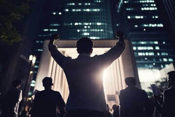 A crowd participates in a nighttime protest, with individuals raising their fists defiantly against a backdrop of illuminated skyscrapers. Generative AI