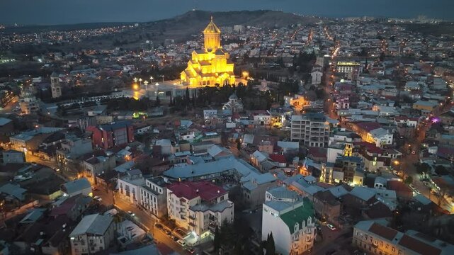 Impressive view of Sameba Cathedral in Tbilisi, taken with a drone in the evening. The drone makes a close rotation around the dome, revealing the magnificence of the cathedral.