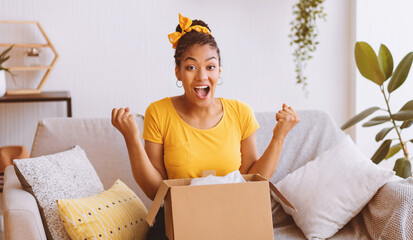 Yes. Emotional black female buyer customer received long-awaited package, screaming with joy, opening cardboard box at home, satisfied with great purchase. Reliable postal courier service concept