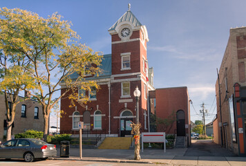 The building of Port Perry Post Office on Queen Street in the town of Port Perry in Ontario, Canada. The structure is a two-storey red brick building with a white dressed-stone foundation and a clock