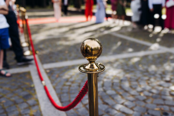 Red carpet with ropes and golden barriers on a luxury party entrance, cinema premiere tv film...