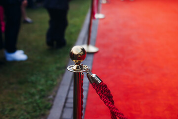 Red carpet with ropes and golden barriers on a luxury party entrance, cinema premiere tv film...