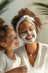 Mother and daughter share a beauty moment with face mask and happy smiles.