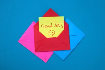 A red envelope containing a yellow sticky note that says 