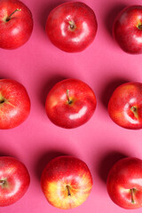 Fresh ripe red apples on pink background, flat lay