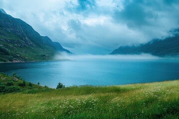Fototapeta premium Misty fjord, green hills, and calm water. Perfect for travel, nature, or serenity themes.