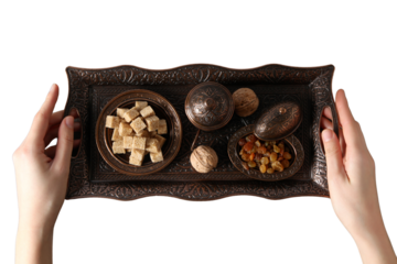 PNG, Ramadan. Copper tray with traditional food - dried fruits, with hands, isolated on white background.