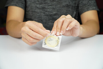 Person is opening a condom package