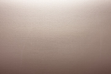 Close-up of a smooth beige surface with subtle texture.