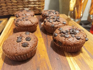 Chocolate Chip Muffins On A Wooden Board With Brown Backgrounds